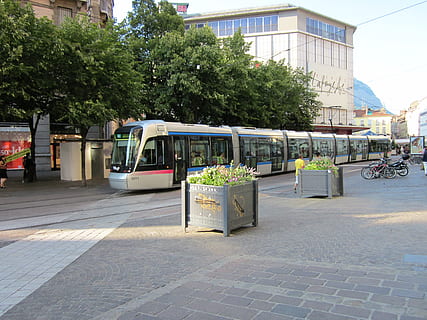 trolley, square, view, street, city, transportation, plant, architecture, tree, built structure, mode of transportation, building exterior, land vehicle, day, incidental people, footpath, outdoors, nature, public transportation, sidewalk, road, city life, communication, paving stone, 4K, CC0, public domain, royalty free