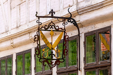 tailor, divorced, old, no people, built structure, architecture, communication, day, building exterior, lighting equipment, sign, text, outdoors, metal, building, design, yellow, pattern, guidance, iron - metal, wall - building feature, entrance, lantern, wrought iron, electric lamp, 4K, CC0, public domain, royalty free