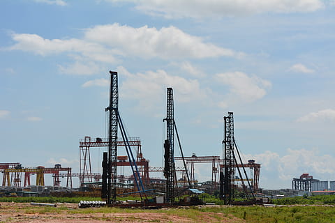 labor, construction site, industry, sky, cloud - sky, architecture, built structure, factory, no people, day, nature, machinery, fuel and power generation, metal, outdoors, crane - construction machinery, development, technology, construction industry, tall - high, building exterior, industrial equipment, 5K, CC0, public domain, royalty free