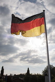 flag, sky, flagpole, wind, cloud, germany flag, germany, cloud - sky, patriotism, low angle view, nature, no people, tree, yellow, pole, day, plant, outdoors, environment, red, striped, pride, architecture, 4K, CC0, public domain, royalty free
