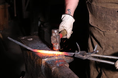 blacksmith, forge, hammer, heat - temperature, fire, burning, flame, working, human hand, workshop, fire - natural phenomenon, hand, human body part, occupation, one person, industry, indoors, metal industry, work tool, craft, skill, glass, melting, preparation, 5K, CC0, public domain, royalty free
